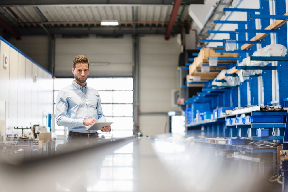 businessman-using-tablet-in-production-hall